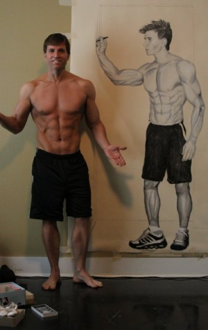 Greg Stevens posing with self-portrait