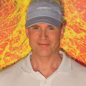 2018 Greg wearing "Positivity" cap